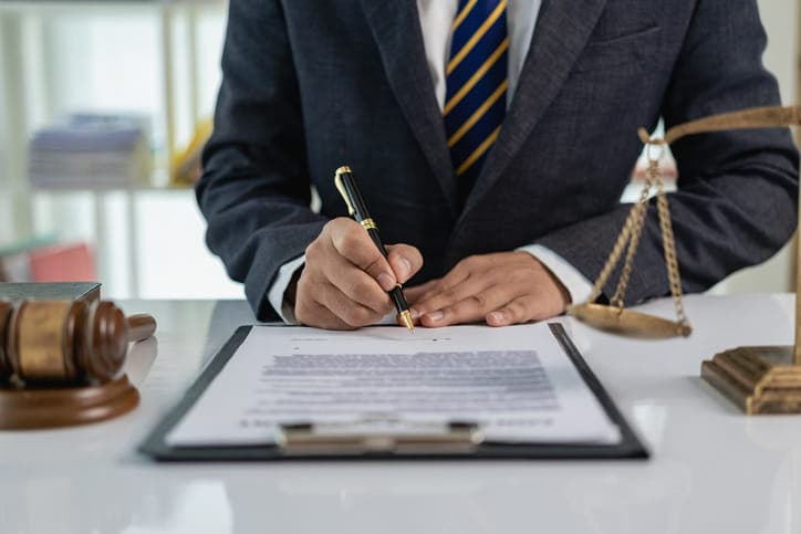 A car accident attorney is working on paperwork at his desk