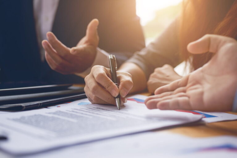 lawyer consulting clients while they sign motorcycle claim documents