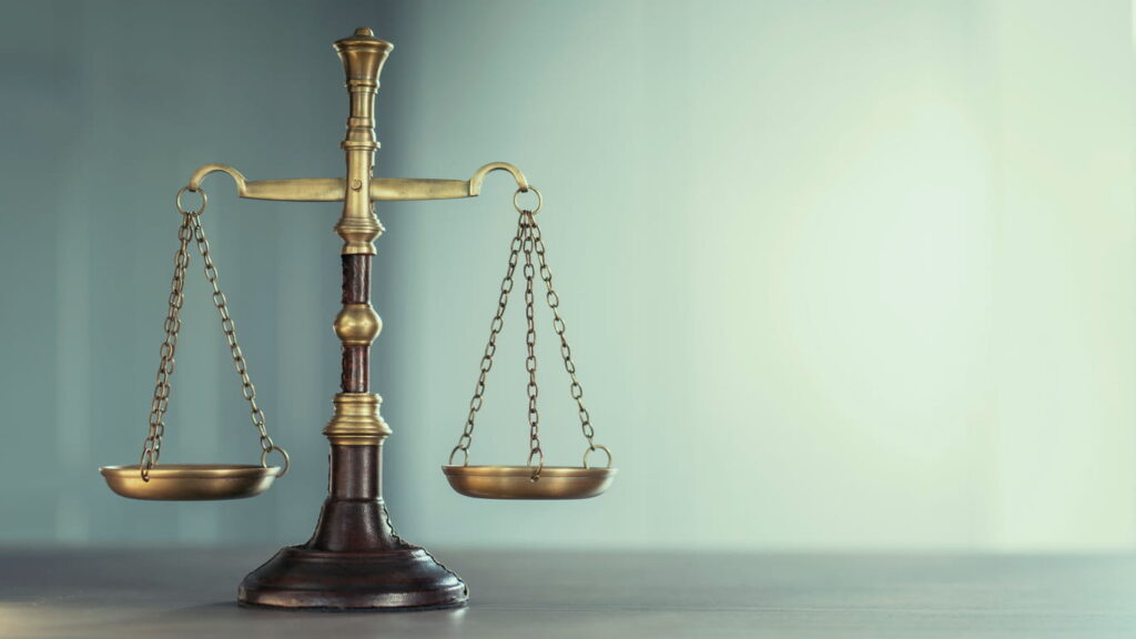 The scales of justice on an auto accident lawyers desk