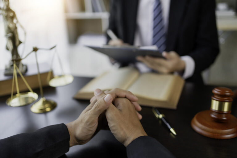 catastrophic injury attorney and their client sitting on a desk